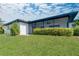 A charming single-story home featuring a cozy screened-in patio and a well-maintained lawn area at 1606 Jim Jim Ct, Venice, FL 34293