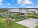 A community center, pools, bocce ball court, sand volleyball, manicured lawn and palm trees at 16455 Whale Grey Pl, Bradenton, FL 34211