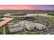 Aerial view of community clubhouse featuring pools, tennis courts, and stunning water views at 16455 Whale Grey Pl, Bradenton, FL 34211