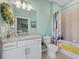Well-lit bathroom featuring stylish light fixtures, granite countertop, and colorful accents at 16455 Whale Grey Pl, Bradenton, FL 34211