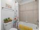 Well-lit bathroom with a shower and tub combo, and a decorative floral shower curtain at 16455 Whale Grey Pl, Bradenton, FL 34211