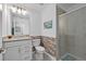 Charming bathroom features modern vanity, granite counters, and a decorative brick accent wall at 16455 Whale Grey Pl, Bradenton, FL 34211