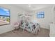 Bright bedroom with a bunk bed, comfortable chair, and natural light from two windows at 16455 Whale Grey Pl, Bradenton, FL 34211
