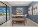 Cozy dining room with modern decor, a sliding glass door, and views of the outdoor pool area at 16455 Whale Grey Pl, Bradenton, FL 34211