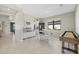 Bright dining area with white tile flooring, complemented by an elegant hutch and a wooden dining table set for four at 16455 Whale Grey Pl, Bradenton, FL 34211
