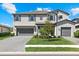 Charming two-story home featuring a spacious three-car garage and manicured lawn at 16455 Whale Grey Pl, Bradenton, FL 34211