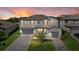 Stunning two-story home with beautiful landscaping and a brick paver driveway at sunset at 16455 Whale Grey Pl, Bradenton, FL 34211