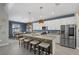 Kitchen featuring stainless steel appliances, a large island with seating, and modern pendant lighting at 16455 Whale Grey Pl, Bradenton, FL 34211