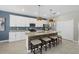 Kitchen featuring stainless steel appliances, a large island with seating, and modern pendant lighting at 16455 Whale Grey Pl, Bradenton, FL 34211