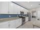 Well-equipped kitchen featuring stainless steel appliances, granite countertops, and white cabinets at 16455 Whale Grey Pl, Bradenton, FL 34211