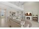 Bright living room featuring a fireplace, beach themed artwork, and an open floor plan to the second story at 16455 Whale Grey Pl, Bradenton, FL 34211