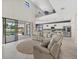 Spacious living room with high ceilings, sliding glass doors, and an open floor plan to the kitchen and dining area at 16455 Whale Grey Pl, Bradenton, FL 34211