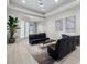 Relaxing lobby with contemporary black sofas, a tropical plant, gray rug, and modern art at 16455 Whale Grey Pl, Bradenton, FL 34211