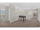 Carpeted loft space with a foosball table, white railings, and neutral paint, creating a fun and airy atmosphere at 16455 Whale Grey Pl, Bradenton, FL 34211