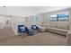 Upstairs living area with comfortable sofa, chairs, and lots of light, great for relaxing and socializing at 16455 Whale Grey Pl, Bradenton, FL 34211