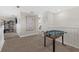 Second floor loft area with a foosball table and neutral paint, great for relaxing and entertaining at 16455 Whale Grey Pl, Bradenton, FL 34211