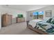 Bright main bedroom with stylish furnishings, a large window, and calming decor for a relaxing atmosphere at 16455 Whale Grey Pl, Bradenton, FL 34211