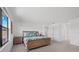 Bright main bedroom featuring a tropical-themed bed set and ample natural light, creating a peaceful retreat at 16455 Whale Grey Pl, Bradenton, FL 34211