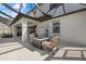 This covered patio includes comfortable seating with a fire table at 16455 Whale Grey Pl, Bradenton, FL 34211