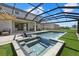 This screened-in lanai includes a stunning pool and spa with a view of the yard and adjacent lake at 16455 Whale Grey Pl, Bradenton, FL 34211