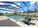Resort-style pool and spa surrounded by lush landscaping, enclosed within a screened lanai at 16455 Whale Grey Pl, Bradenton, FL 34211