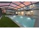 An incredible pool area is shown at dusk, illuminated and ready for an evening swim at 16455 Whale Grey Pl, Bradenton, FL 34211