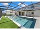 This screened-in lanai includes a stunning pool and spa with artificial turf at 16455 Whale Grey Pl, Bradenton, FL 34211