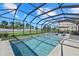 This screened-in lanai includes a stunning pool and spa with artificial turf at 16455 Whale Grey Pl, Bradenton, FL 34211