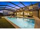 Inviting screened-in pool and spa, surrounded by a spacious patio and lush landscaping, ideal for relaxation and recreation at 16455 Whale Grey Pl, Bradenton, FL 34211