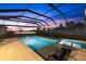 Relaxing screened-in pool and spa overlooking a peaceful pond with stunning sunset views, perfect for outdoor entertaining at 16455 Whale Grey Pl, Bradenton, FL 34211