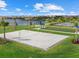 The recreation area includes a beach volleyball court, bocce ball, lush grass and a lake backdrop at 16455 Whale Grey Pl, Bradenton, FL 34211