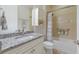 Bathroom featuring granite countertop and shower with tile surround at 16719 Ellsworth Ave, Bradenton, FL 34202