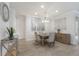 Stylish dining room with a modern chandelier, tiled flooring, and neutral-toned decor at 16719 Ellsworth Ave, Bradenton, FL 34202