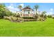 Del Webb Lakewood Ranch entrance with lush landscaping, fountain, and stately signage at 16719 Ellsworth Ave, Bradenton, FL 34202
