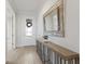 Elegant foyer with tile floors, a console table, decorative mirror, and stylish front door at 16719 Ellsworth Ave, Bradenton, FL 34202