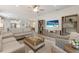 Open-concept living room, blending seamlessly with kitchen, featuring neutral tones and modern decor at 16719 Ellsworth Ave, Bradenton, FL 34202