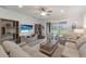 Comfortable living room featuring neutral furniture, a ceiling fan, and view of the outdoors at 16719 Ellsworth Ave, Bradenton, FL 34202