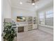 Cozy office with wood-look floors, shutters, a ceiling fan, built-in shelving, and a desk at 16719 Ellsworth Ave, Bradenton, FL 34202