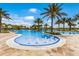 A luxurious swimming pool features multiple sections with fountains and lush palm trees at 16719 Ellsworth Ave, Bradenton, FL 34202