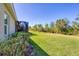 Large grassy backyard offering plenty of room to roam, surrounded by mature landscaping at 21037 Anclote Ct, Venice, FL 34293