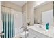 Clean bathroom with a shower-tub combo, a single sink vanity and a large mirror at 21037 Anclote Ct, Venice, FL 34293