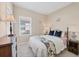 Comfortable bedroom features neutral carpeting, soft lighting, and a window for natural light at 21037 Anclote Ct, Venice, FL 34293