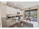 Bright kitchen with white cabinets, granite countertops, and a view of the outdoor patio at 21037 Anclote Ct, Venice, FL 34293