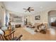 Bright living room with open floor plan, wood floors, and access to kitchen and dining area at 21037 Anclote Ct, Venice, FL 34293