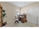 Home office features a built-in desk, wooden chair, a window with natural light, and a closet at 21037 Anclote Ct, Venice, FL 34293