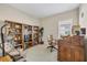Well-organized home office featuring built-in bookshelves, a desk, a chair, and a window at 21037 Anclote Ct, Venice, FL 34293