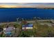 Waterfront home featuring beautiful water views, lush landscaping, and a private dock at 2512 Riverside E Dr, Bradenton, FL 34208