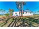 This home offers a beautiful outdoor view with mature trees, lush greenery, and a durable metal roof at 2512 Riverside E Dr, Bradenton, FL 34208