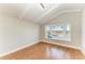 Bright bedroom features hardwood floors, a bay window with view of the ocean, and a white beamed ceiling at 2512 Riverside E Dr, Bradenton, FL 34208