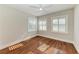 Bedroom with hardwood floors, ceiling fan, and three windows with lots of natural light at 2512 Riverside E Dr, Bradenton, FL 34208